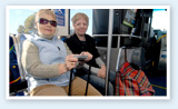 Two female seniors sitting on bus
